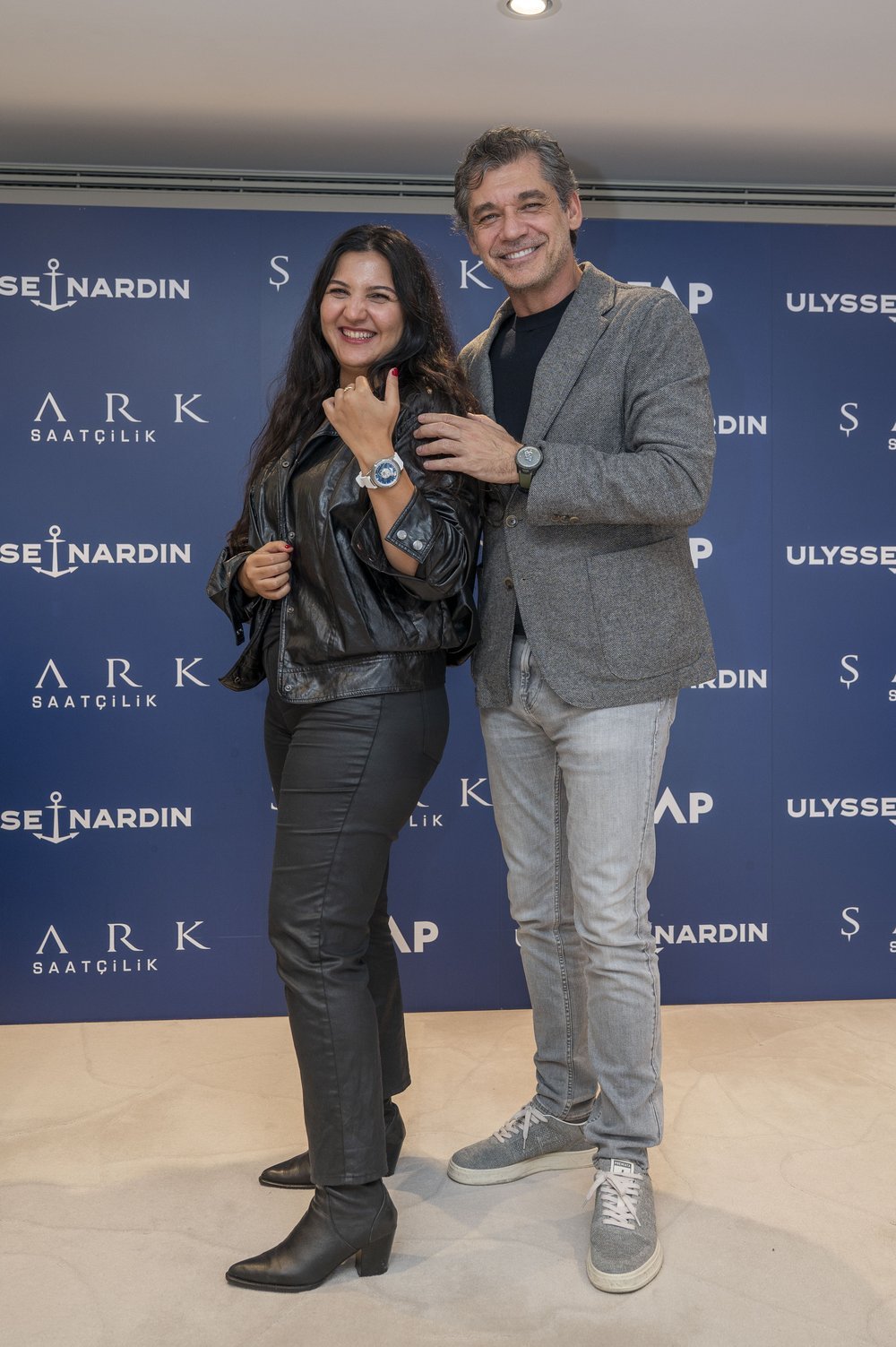 Two guests posing with their watches